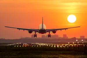 Airplane landing at sunset