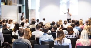 A view of people seated for a conference event