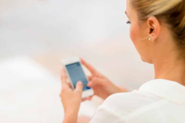 Business woman using app on a smart phone